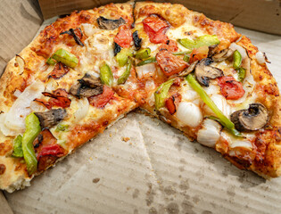 A hand-tossed Mushroom pizza topped with mushrooms, onions, crispy green bell peppers or capsicum,...
