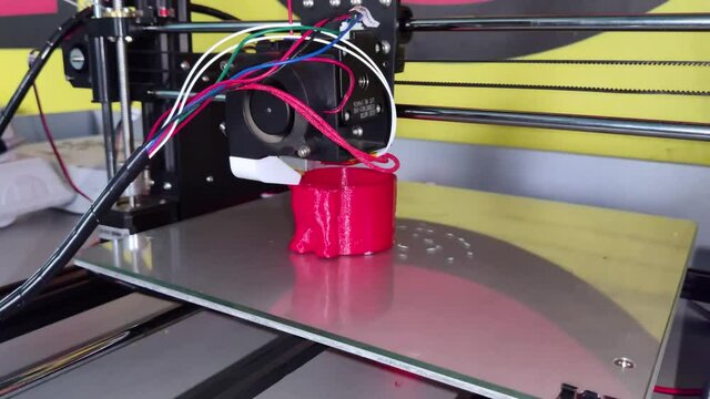 A modern 3D printer at work. Macro photography of a CNC machine that independently creates a volumetric object. The concept of modern technologies and robotization of production