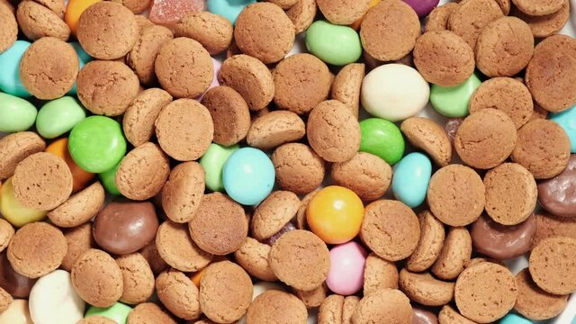 Rotation of kruidnoten, traditional sweets, strooigoed. Background for Dutch holiday Sinterklaas. St. Nicolas day concept. 4K video, 50 fps, top view