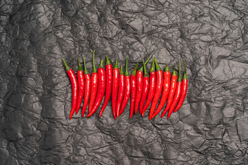 red hot chili peppers in a row on a black background