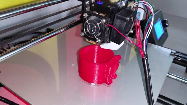 A modern 3D printer at work. Macro photography of a CNC machine that independently creates a volumetric object. The concept of modern technologies and robotization of production