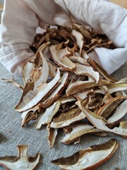 dried mushrooms in a cloth bag on a burlap