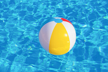 Colorful inflatable ball floating in swimming pool