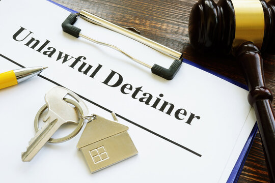 Unlawful detainer papers, key and gavel in the court.