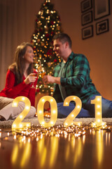 Naklejka na ściany i meble Couple celebrating New Year at home