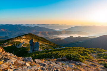 Amazing sunrise high in the mountains. Autumn morning at the mountain top. © Mny-Jhee