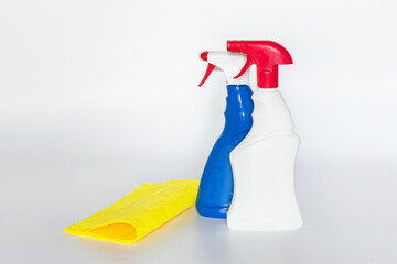 Plastic bottles with chemicals for home cleaning on a white background.