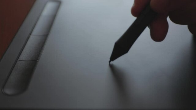 Close up view of graphic designer Drawing with the stylus on a graphics tablet