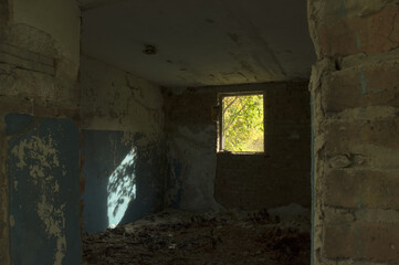 bright sunlight coming through the window of an abandoned building