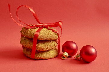 Round cookies with cereals and seeds tied with a red ribbon, Christmas toys