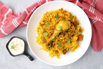 Chicken Biryani/murg Pulao.  Garnished with fried onion & chopped coriander. Biryani served with raita is a famous Spicy non vegetarian dish of India. Along with copy space.