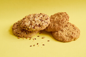 Four cookies with flakes and sesame seeds