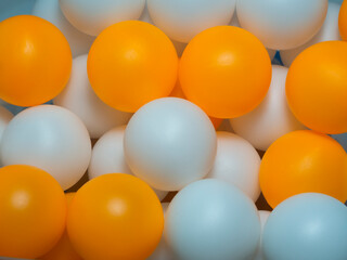Orange and white table tennis balls Mixed colors, full background
