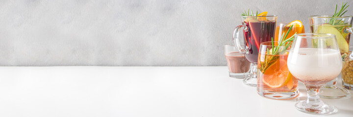 Various autumn winter alcohol drinks set. Different seasonal alcohol cocktails - mulled wine, glogg, grog, eggnog, ginger ale, hot buttered rum, punch, apple cider, sangria, white background