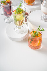 Various autumn winter alcohol drinks set. Different seasonal alcohol cocktails - mulled wine, glogg, grog, eggnog, ginger ale, hot buttered rum, punch, apple cider, sangria, white background