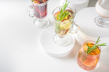Various autumn winter alcohol drinks set. Different seasonal alcohol cocktails - mulled wine, glogg, grog, eggnog, ginger ale, hot buttered rum, punch, apple cider, sangria, white background