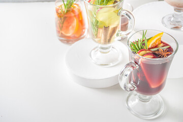 Various autumn winter alcohol drinks set. Different seasonal alcohol cocktails - mulled wine, glogg, grog, eggnog, ginger ale, hot buttered rum, punch, apple cider, sangria, white background