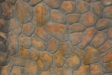 brown stone texture of large cobblestones in the wall of the fence