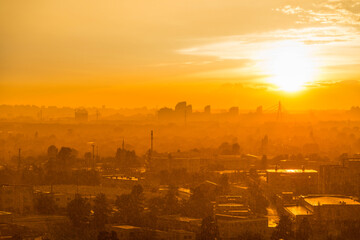 Cityscape with sunset in big city, moderm buildings under dramatic sunset sky