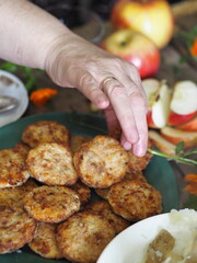 Rustic style. Thanksgiving day celebration concept. There is a lot of food on the wooden table. Guests take healthy homemade natural food with their hands.