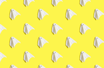 sunlight autumn pattern made with ghost on bright yellow background. Minimal halloween concept