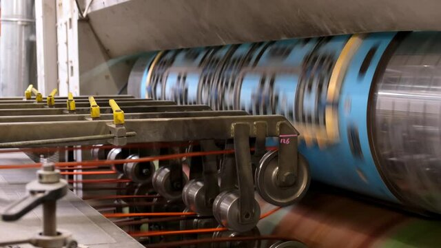 Conveyor line for the production of cardboard boxes. Machine carves cardboard boxes from sheets . Rotary die cutting . Cutting die. Die on the cushion.