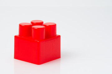 Red cube block constructor on a white background with copy space. Construction idea concept