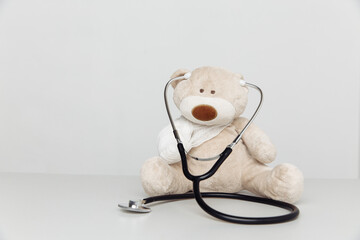 Stuffed Teddy Bear animal with stethoscope as a symbol of children healtcare concept