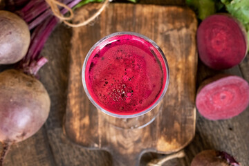 Red beet juice in a glass, top view