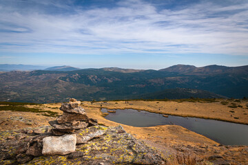 Fototapeta na wymiar Lake on a rocky mountain landscape on Guadarrama mountain range, Peñalara, Madrid, Spain