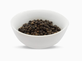 Black pepper, herbs, spices in a white bowl.