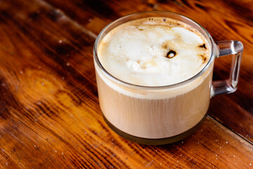 cappuccino latte in a glass on wooden table