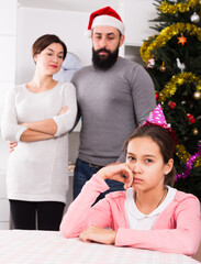 Father and mother telling off their daughter for disobedience at Christmas
