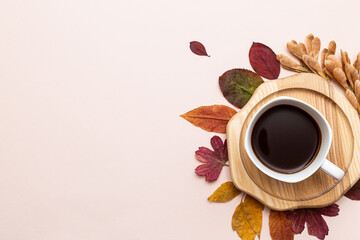 Cup of coffee and autumn leaves top view. Cozy home autumn concept