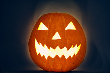 halloween pumpkin with light bulb and backlit scary zigzag muzzle. hedgehog. High quality photo