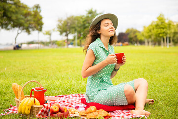 Beautiful young woman having picnic.