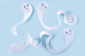 Halloween decorarion. Concept DIY and children creativity. Step-by-step instructions: making ghosts from white paper. Step 4 finished ghost figures