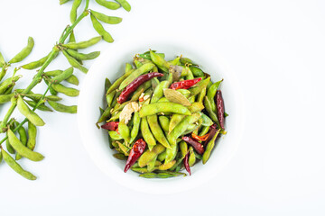 A pot of delicious spicy edamame on white background