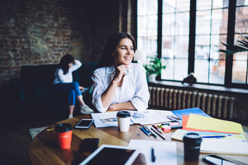 Cheerful woman working in loft cafe