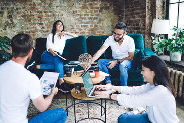 Cheerful colleagues working together in cafe