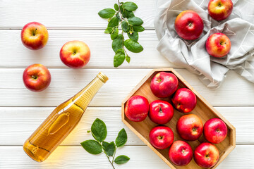 Top view of apple cider or vinegar - bottle with ripe fruits and leaves