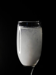 glass of water with white paint