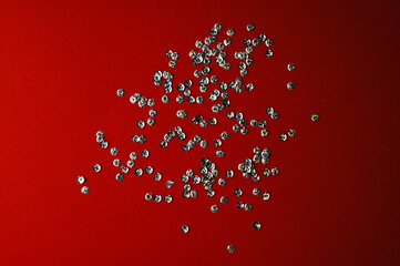 shiny confetti scattered on red background