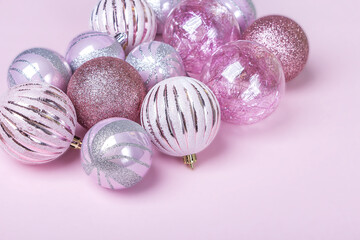 Christmas composition. Set of christmas pink decorations, shiny balls on pastel background. Mock up for new year gretting card. Copy space for text or lettering