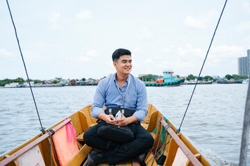 Business man travel by a boat in Bangkok.