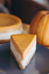 Piece of pumpkin homemade cake. Festive dessert concept. pumpkin tart on cozy cafe background, selective focus, noise effect