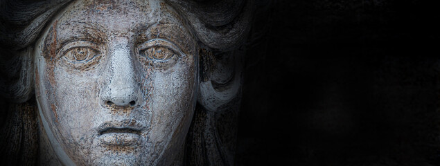 Fototapeta na wymiar Banner with ancient aged sculpture of beautiful Venetian Renaissance Era woman face in Venice, Italy, isolated at black background, closeup, details.