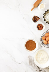 Baking background with ingredients standing on a marble table surface