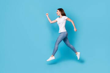 Fototapeta na wymiar Full length body size profile side view of her she nice attractive purposeful slim fit skinny cheerful girl jumping running marathon motion isolated bright vivid shine vibrant blue color background
