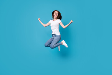 Fototapeta na wymiar Full length body size view of her she attractive pretty slim skinny glad overjoyed lucky cheerful girl jumping celebrating having fun vacation isolated bright vivid shine vibrant blue color background